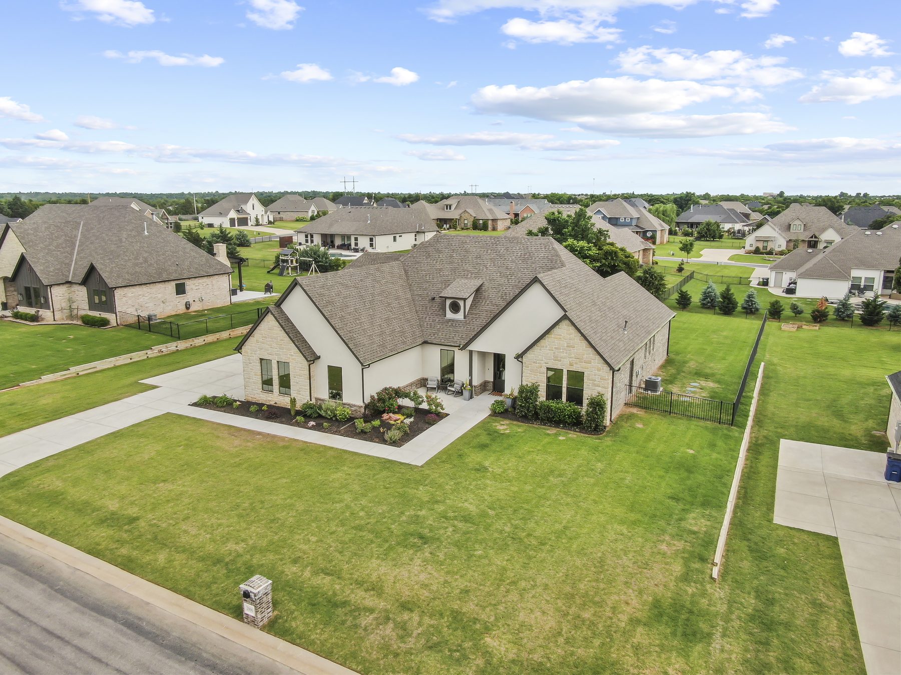Aerial drone view of a home and its lot in a suburban neighborhood